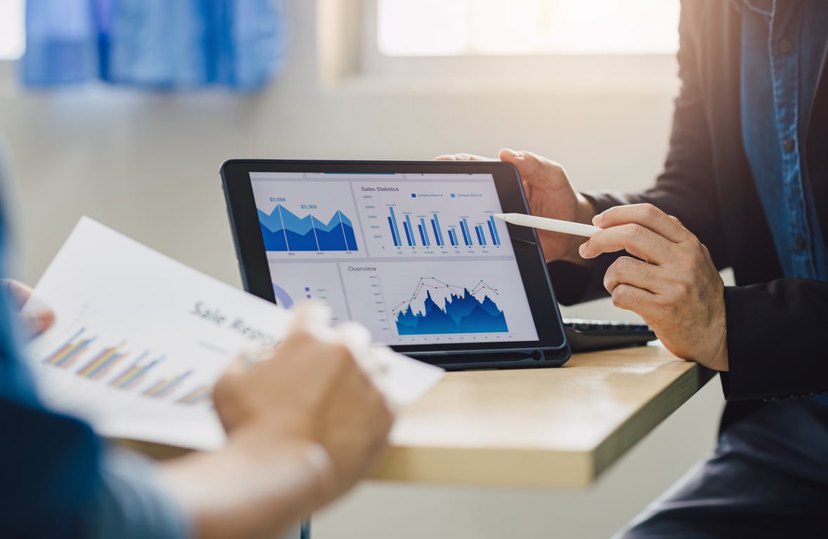 Two businessman in business meeting consult SWOT analyzing company financial cash flow result.